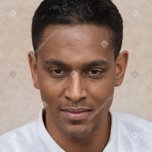 Joyful black young-adult male with short  brown hair and brown eyes