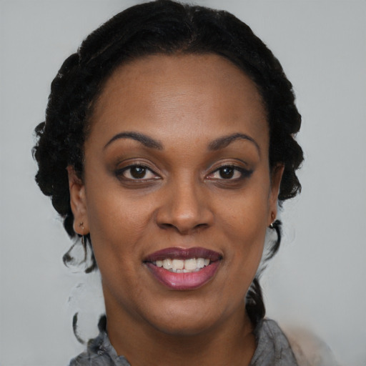 Joyful black young-adult female with short  brown hair and brown eyes