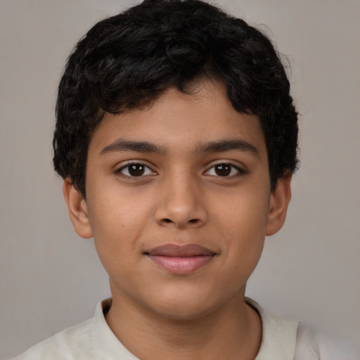 Joyful latino child male with short  brown hair and brown eyes