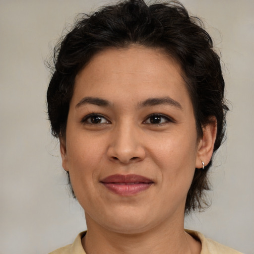 Joyful latino adult female with medium  brown hair and brown eyes