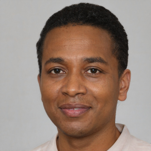 Joyful latino adult male with short  black hair and brown eyes