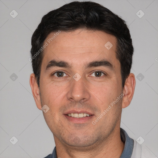 Joyful white young-adult male with short  black hair and brown eyes