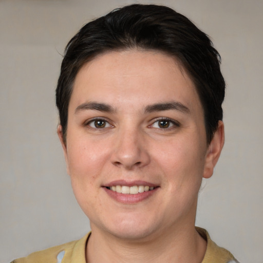 Joyful white young-adult female with short  brown hair and brown eyes