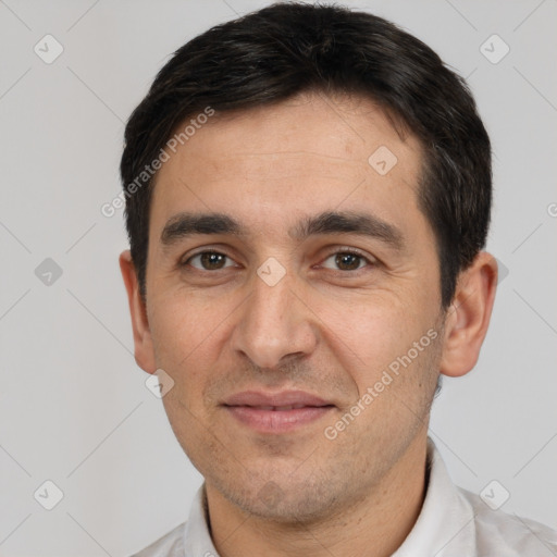 Joyful white adult male with short  black hair and brown eyes