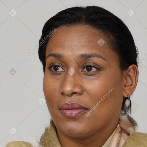 Joyful black adult female with medium  brown hair and brown eyes