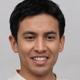 Joyful asian young-adult male with short  brown hair and brown eyes