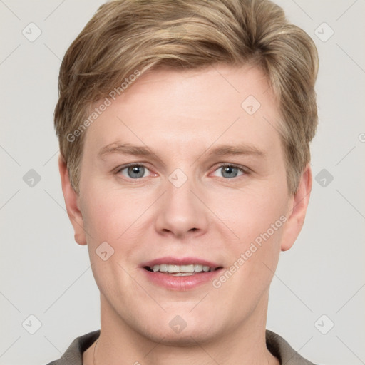 Joyful white young-adult male with short  brown hair and grey eyes