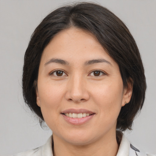 Joyful white young-adult female with medium  brown hair and brown eyes