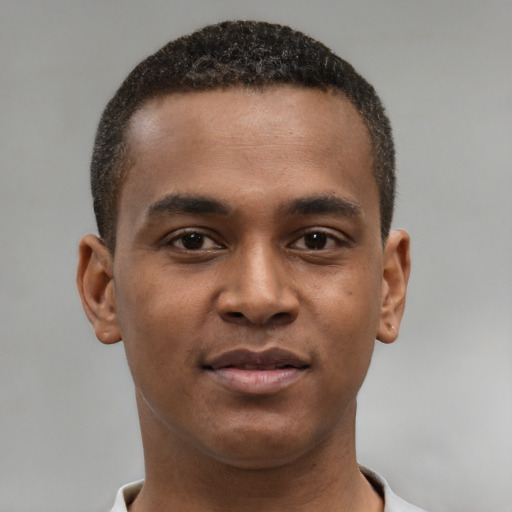 Joyful black young-adult male with short  brown hair and brown eyes