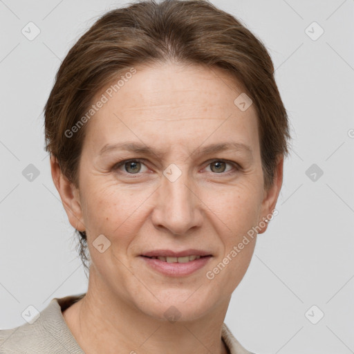 Joyful white adult female with short  brown hair and grey eyes