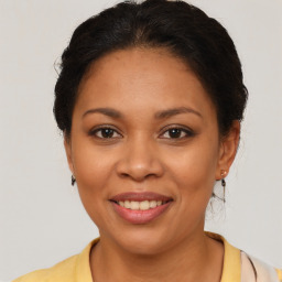 Joyful latino young-adult female with medium  brown hair and brown eyes