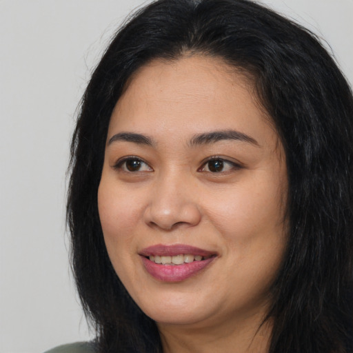 Joyful asian young-adult female with long  black hair and brown eyes