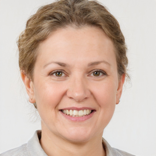 Joyful white adult female with short  brown hair and grey eyes