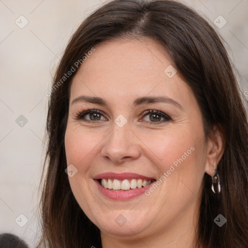 Joyful white adult female with long  brown hair and brown eyes