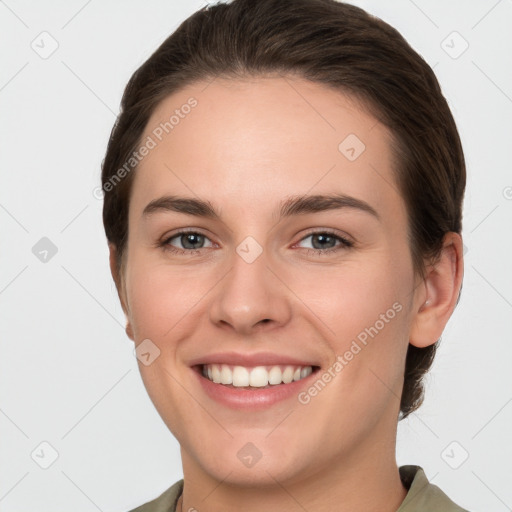 Joyful white young-adult female with short  brown hair and grey eyes