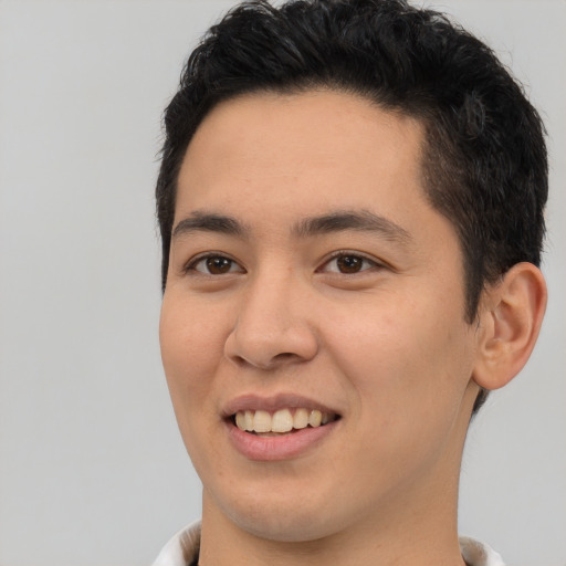 Joyful latino young-adult male with short  brown hair and brown eyes