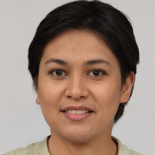 Joyful latino adult female with short  brown hair and brown eyes