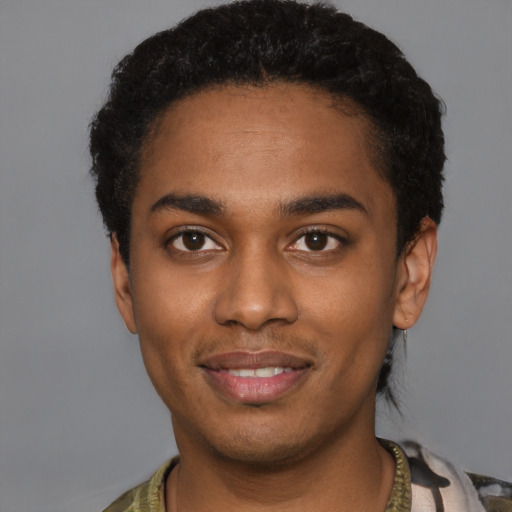 Joyful black young-adult male with short  black hair and brown eyes