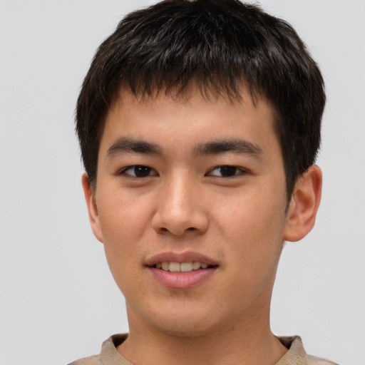Joyful asian young-adult male with short  brown hair and brown eyes