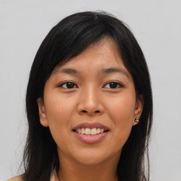 Joyful asian young-adult female with long  brown hair and brown eyes