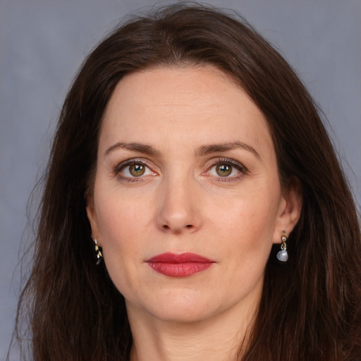 Joyful white adult female with long  brown hair and brown eyes