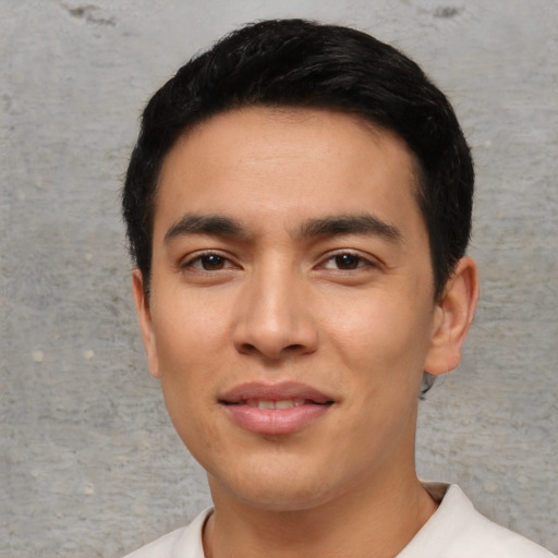 Joyful asian young-adult male with short  black hair and brown eyes