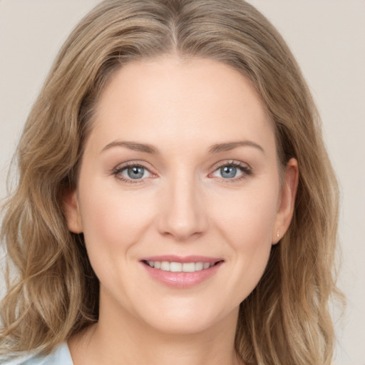 Joyful white young-adult female with long  brown hair and blue eyes