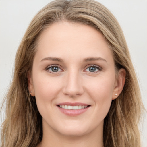 Joyful white young-adult female with long  brown hair and blue eyes