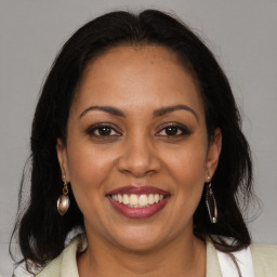 Joyful black young-adult female with medium  brown hair and brown eyes