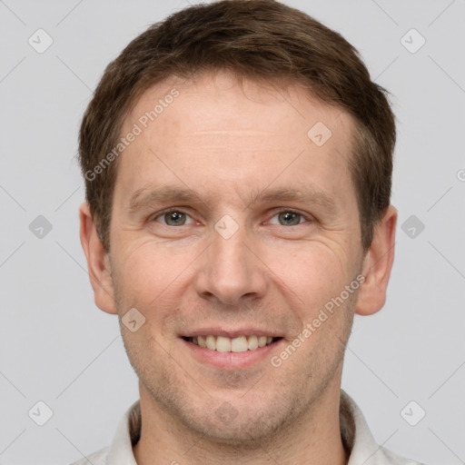 Joyful white adult male with short  brown hair and grey eyes