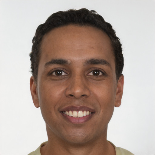 Joyful black young-adult male with short  black hair and brown eyes