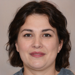 Joyful white adult female with medium  brown hair and brown eyes