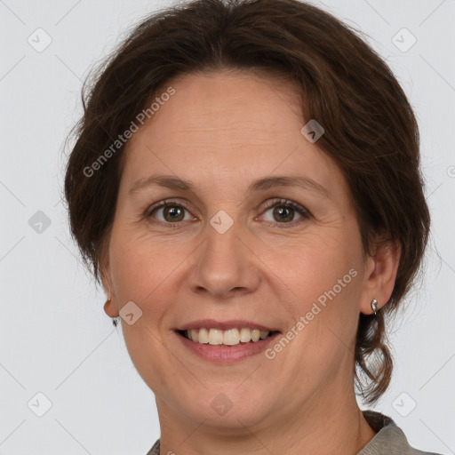 Joyful white adult female with medium  brown hair and grey eyes