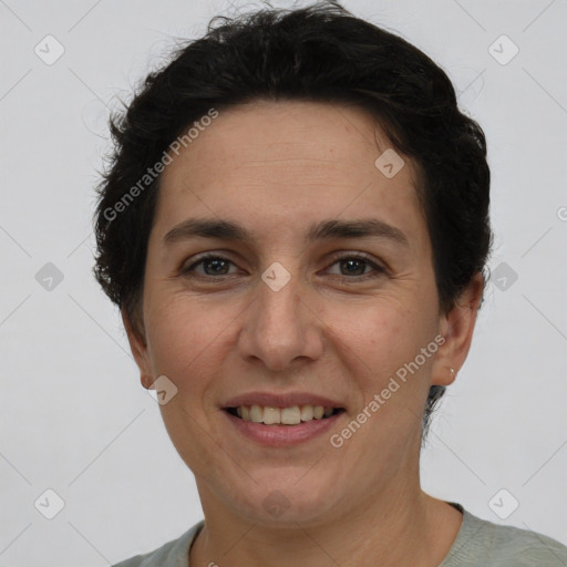 Joyful white adult female with short  brown hair and brown eyes