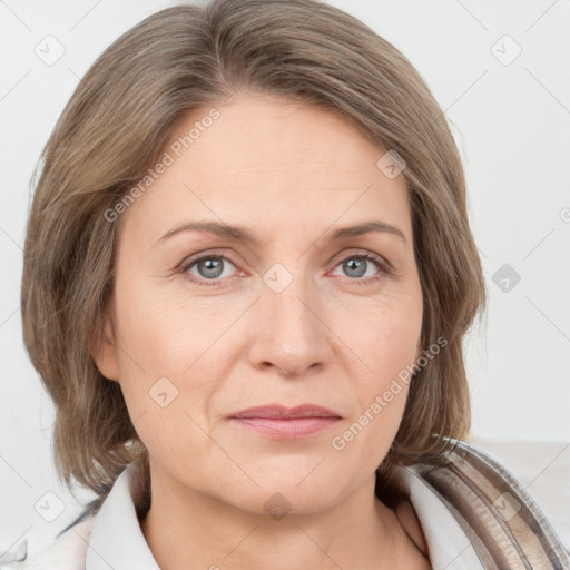 Joyful white adult female with medium  brown hair and grey eyes