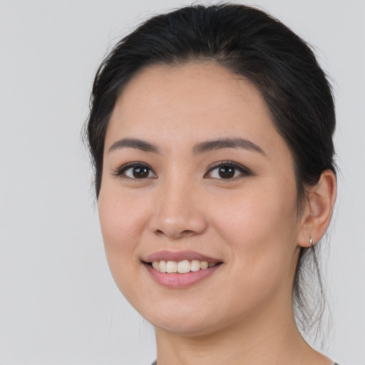 Joyful asian young-adult female with long  brown hair and brown eyes
