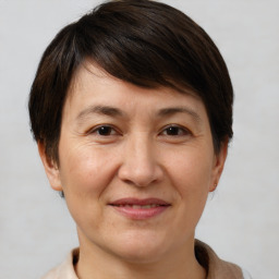 Joyful white adult female with short  brown hair and brown eyes