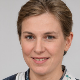 Joyful white adult female with medium  brown hair and grey eyes