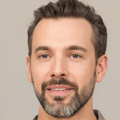 Joyful white adult male with short  brown hair and brown eyes