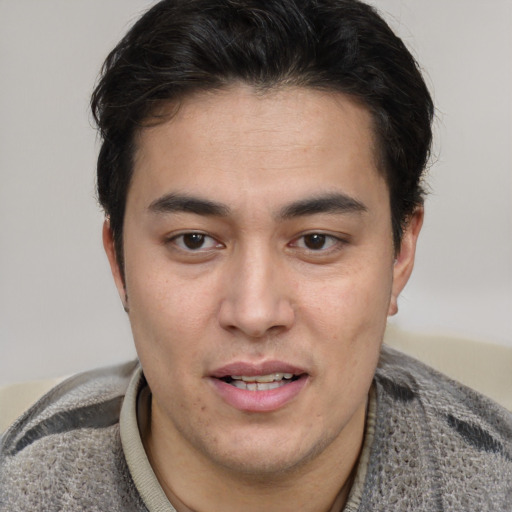 Joyful latino young-adult male with short  brown hair and brown eyes