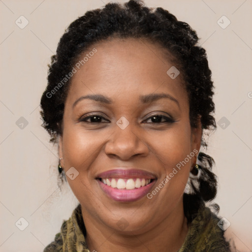 Joyful black adult female with long  brown hair and brown eyes