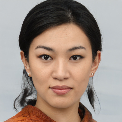 Joyful asian young-adult female with medium  brown hair and brown eyes