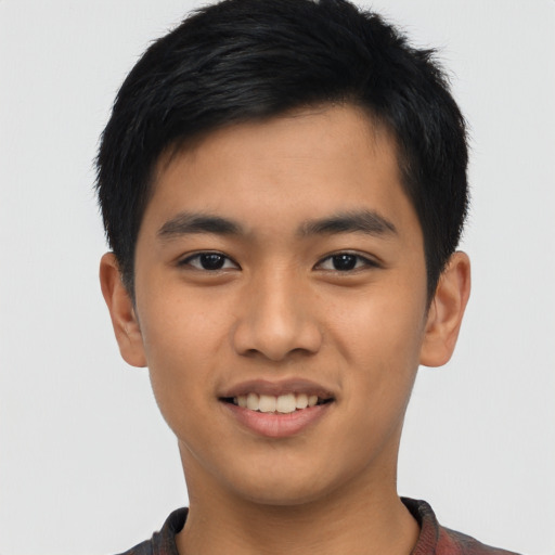 Joyful asian young-adult male with short  black hair and brown eyes