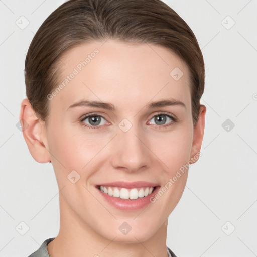 Joyful white young-adult female with short  brown hair and grey eyes