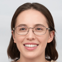 Joyful white young-adult female with medium  brown hair and blue eyes