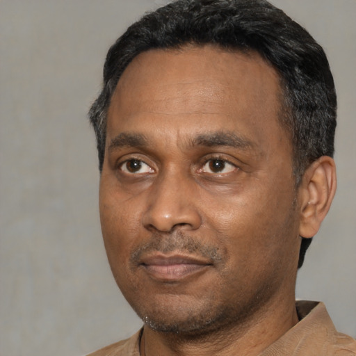 Neutral black adult male with short  black hair and brown eyes