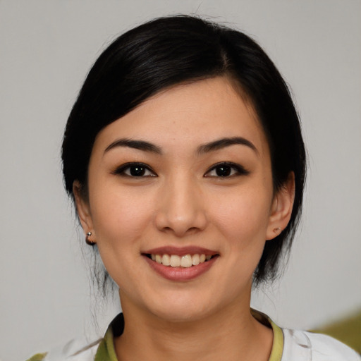 Joyful white young-adult female with medium  black hair and brown eyes