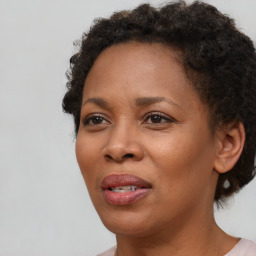 Joyful black adult female with short  brown hair and brown eyes