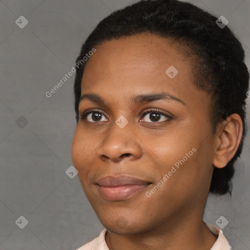 Joyful black young-adult female with short  brown hair and brown eyes