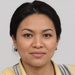 Joyful latino young-adult female with medium  brown hair and brown eyes